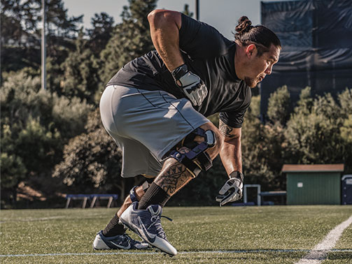 Footbal player with knee brace